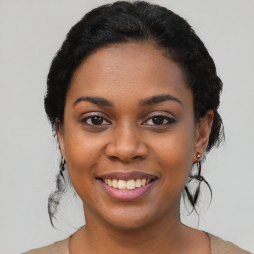 Joyful black young-adult female with medium  black hair and brown eyes