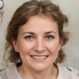 Joyful white young-adult female with medium  brown hair and blue eyes