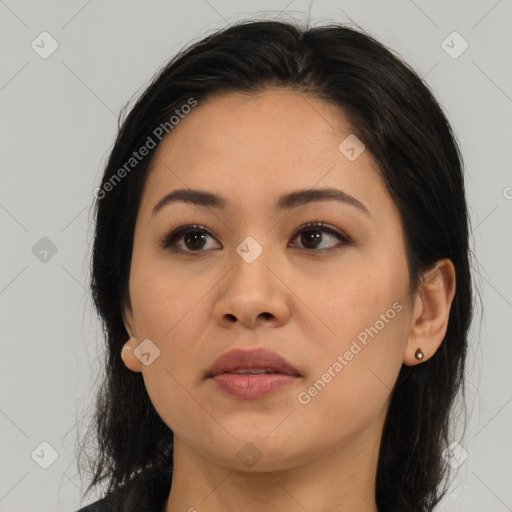 Joyful latino young-adult female with long  brown hair and brown eyes