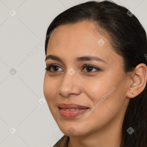 Joyful latino young-adult female with long  brown hair and brown eyes