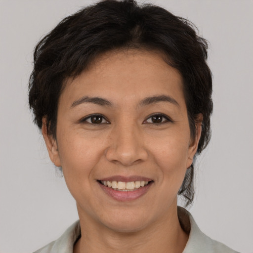 Joyful asian young-adult female with short  brown hair and brown eyes