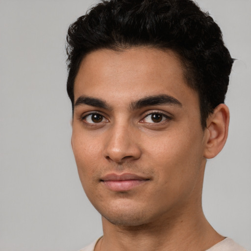 Joyful white young-adult male with short  black hair and brown eyes