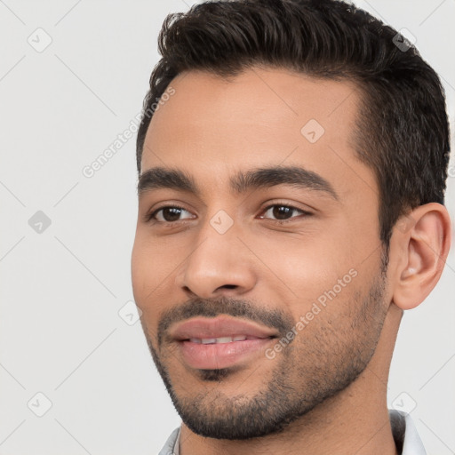 Joyful white young-adult male with short  black hair and brown eyes