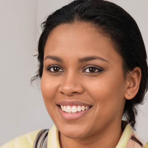 Joyful latino young-adult female with medium  brown hair and brown eyes