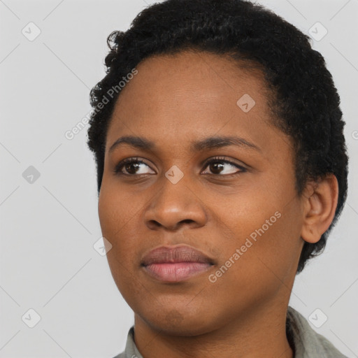 Joyful black young-adult female with short  black hair and brown eyes