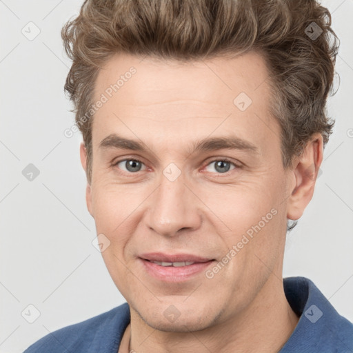 Joyful white adult male with short  brown hair and grey eyes