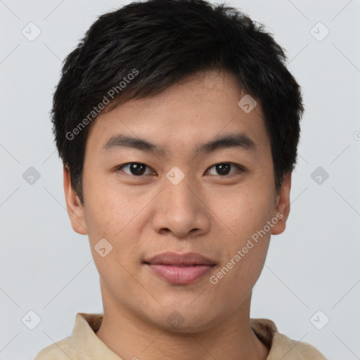 Joyful asian young-adult male with short  brown hair and brown eyes