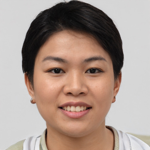 Joyful asian young-adult female with short  brown hair and brown eyes