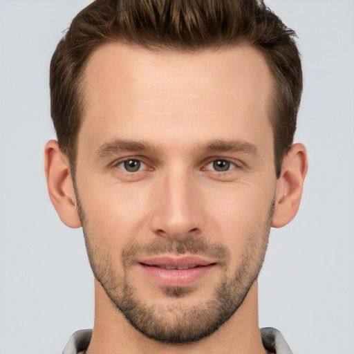 Joyful white young-adult male with short  brown hair and brown eyes