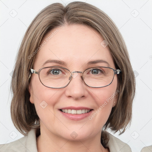 Joyful white adult female with medium  brown hair and blue eyes