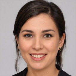 Joyful white young-adult female with medium  brown hair and brown eyes