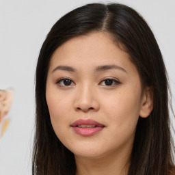 Joyful asian young-adult female with long  brown hair and brown eyes