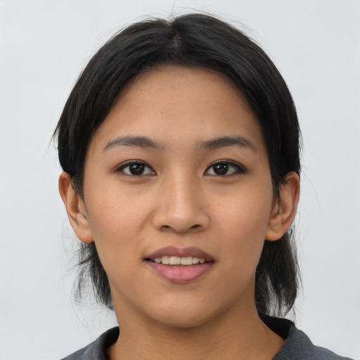 Joyful asian young-adult female with medium  black hair and brown eyes