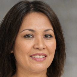 Joyful white adult female with long  brown hair and brown eyes