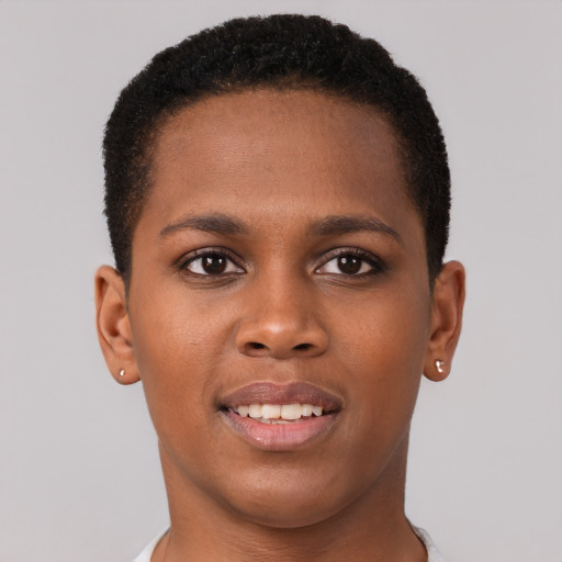 Joyful black young-adult female with short  brown hair and brown eyes