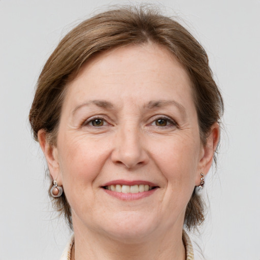 Joyful white adult female with medium  brown hair and grey eyes