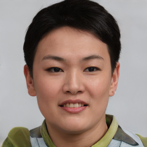 Joyful asian young-adult female with short  black hair and brown eyes