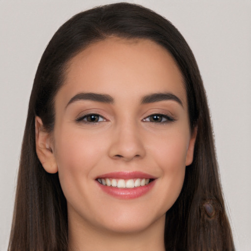 Joyful white young-adult female with long  brown hair and brown eyes