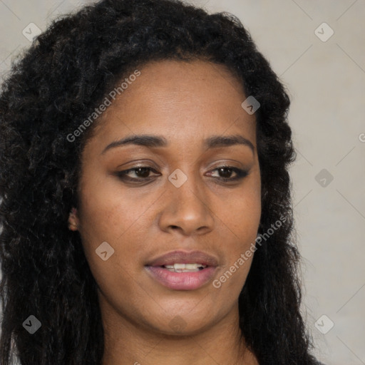 Joyful black young-adult female with long  brown hair and brown eyes