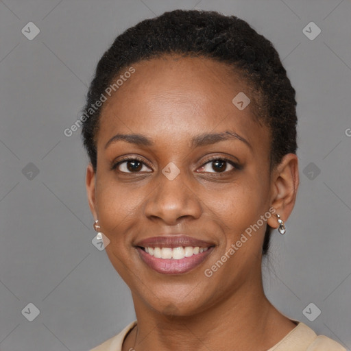 Joyful black young-adult female with short  brown hair and brown eyes