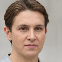 Joyful white adult male with short  brown hair and grey eyes