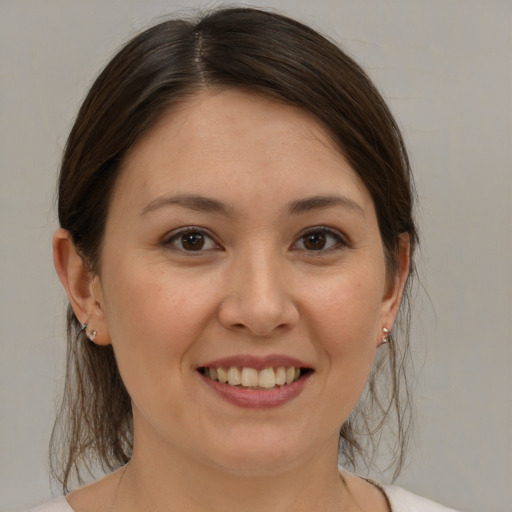 Joyful white young-adult female with medium  brown hair and brown eyes