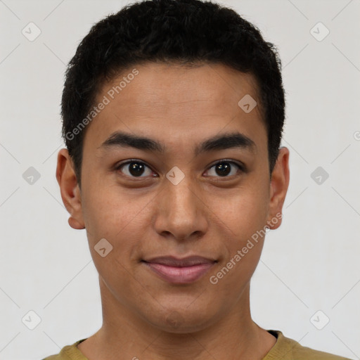 Joyful latino young-adult male with short  brown hair and brown eyes