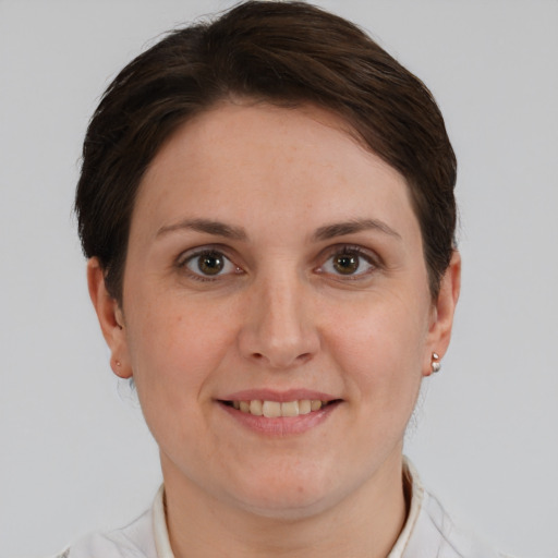 Joyful white young-adult female with short  brown hair and grey eyes