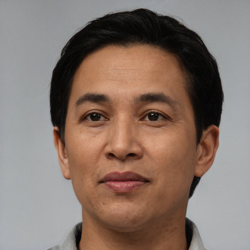 Joyful asian adult male with short  black hair and brown eyes