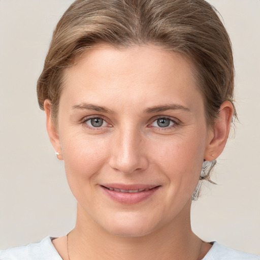 Joyful white young-adult female with short  brown hair and grey eyes