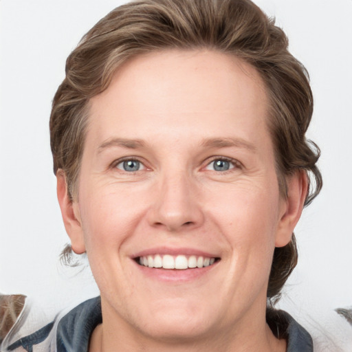 Joyful white adult female with medium  brown hair and grey eyes