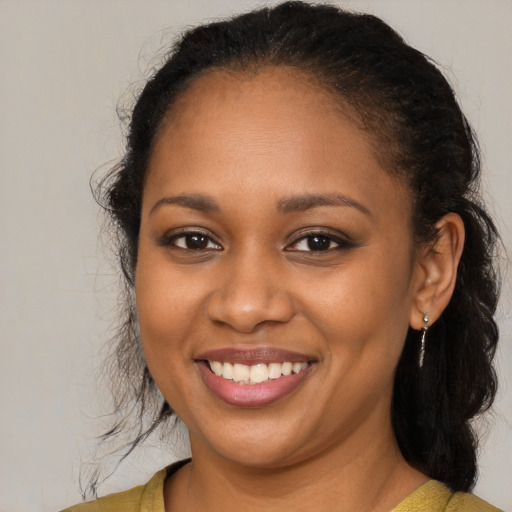 Joyful black young-adult female with medium  brown hair and brown eyes