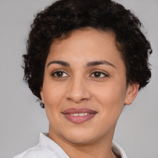 Joyful latino young-adult female with short  brown hair and brown eyes