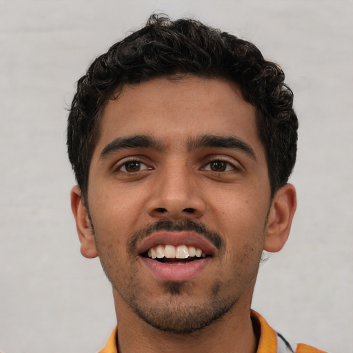 Joyful white young-adult male with short  black hair and brown eyes