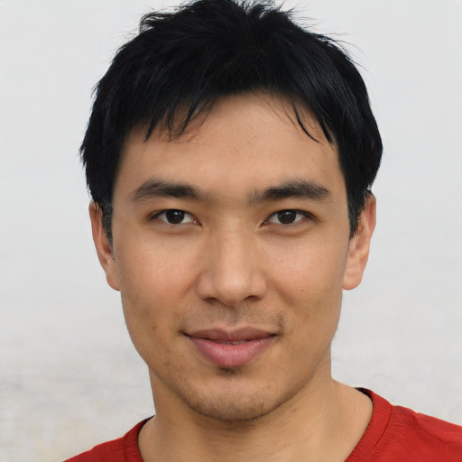 Joyful asian young-adult male with short  black hair and brown eyes