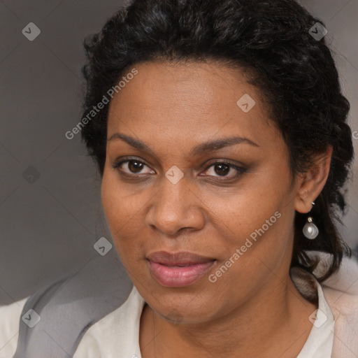 Joyful black adult female with long  brown hair and brown eyes