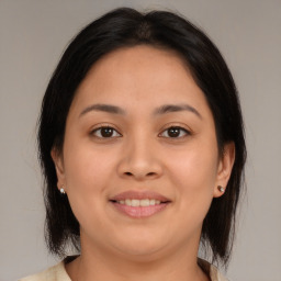 Joyful latino young-adult female with medium  brown hair and brown eyes