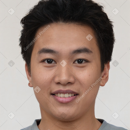 Joyful asian young-adult male with short  brown hair and brown eyes