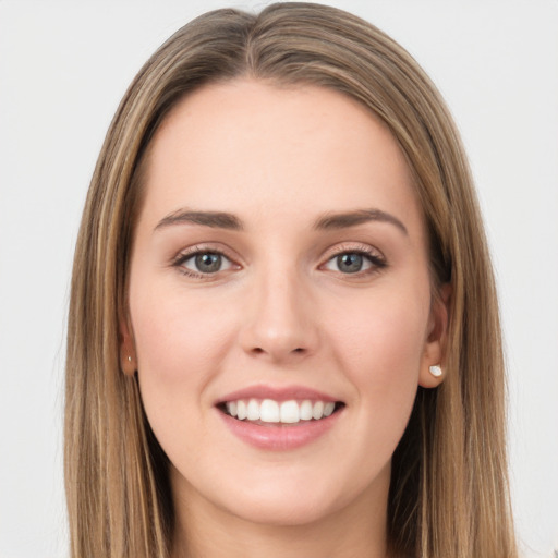 Joyful white young-adult female with long  brown hair and green eyes