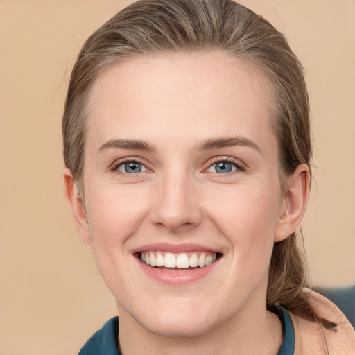 Joyful white young-adult female with short  brown hair and grey eyes