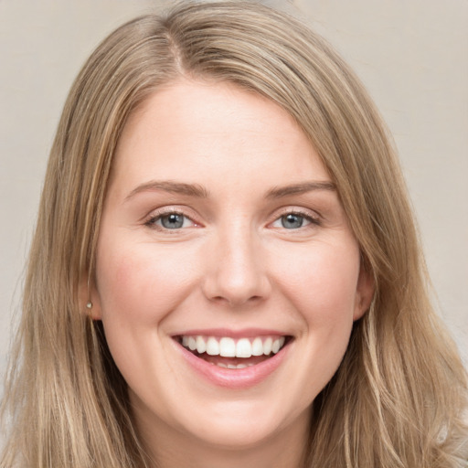 Joyful white young-adult female with long  brown hair and grey eyes