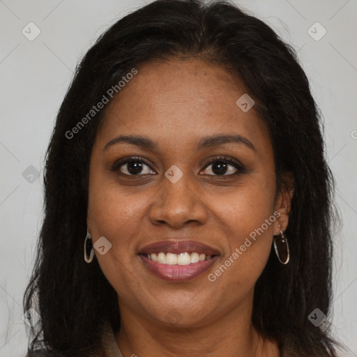 Joyful black young-adult female with long  brown hair and brown eyes