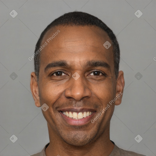 Joyful black young-adult male with short  black hair and brown eyes