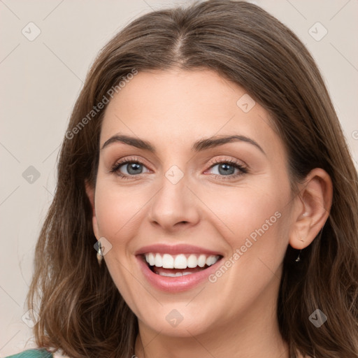 Joyful white young-adult female with long  brown hair and green eyes