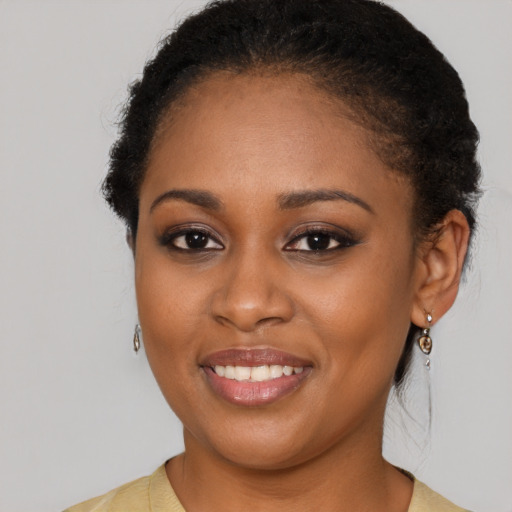 Joyful black young-adult female with medium  brown hair and brown eyes