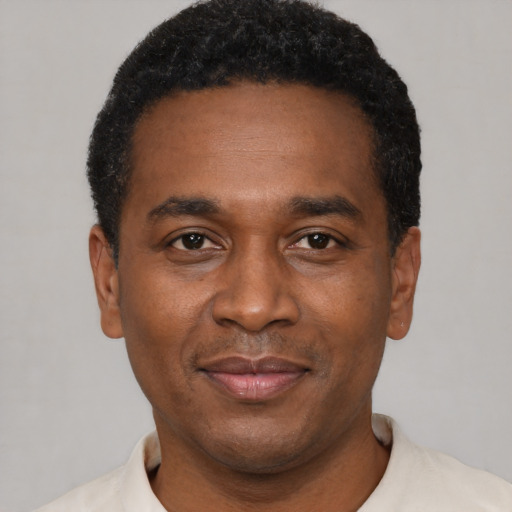 Joyful latino adult male with short  black hair and brown eyes