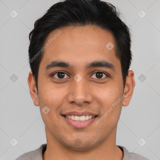 Joyful latino young-adult male with short  brown hair and brown eyes