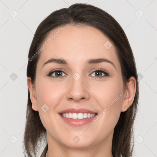 Joyful white young-adult female with long  brown hair and grey eyes