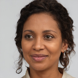 Joyful black adult female with medium  brown hair and brown eyes