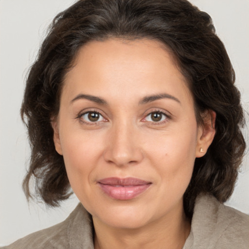 Joyful white adult female with medium  brown hair and brown eyes